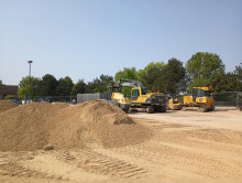 2023-05-25 - A dirt pile with construction equipment in the background